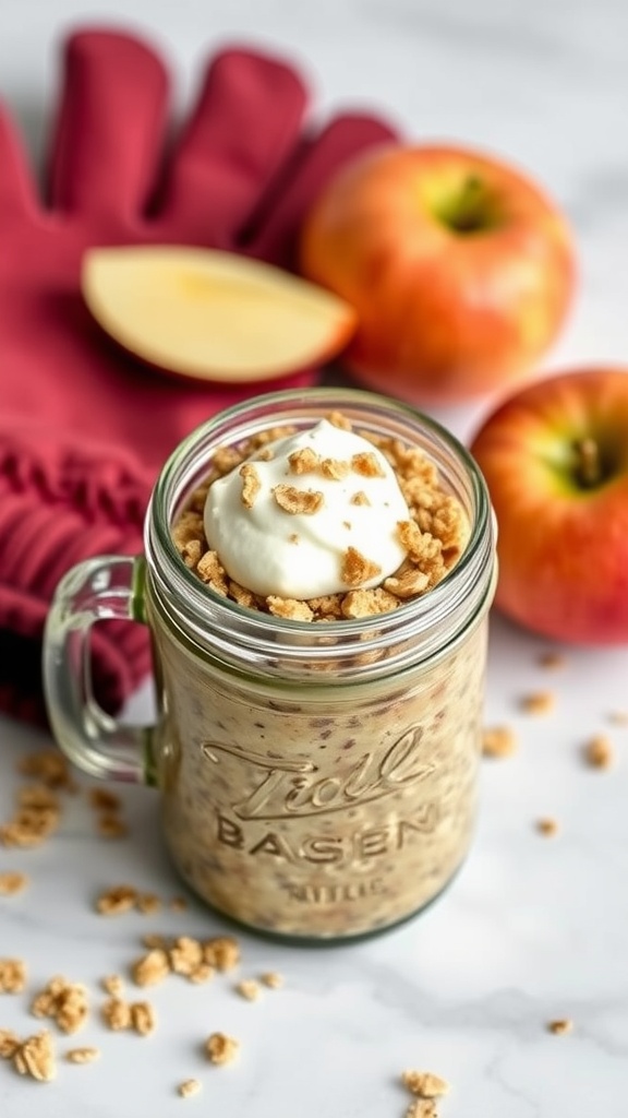 A jar of baked apple overnight oats topped with yogurt and granola, with apples in the background.