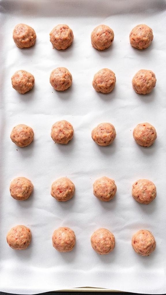 Shaped meatballs on a baking sheet ready for baking.