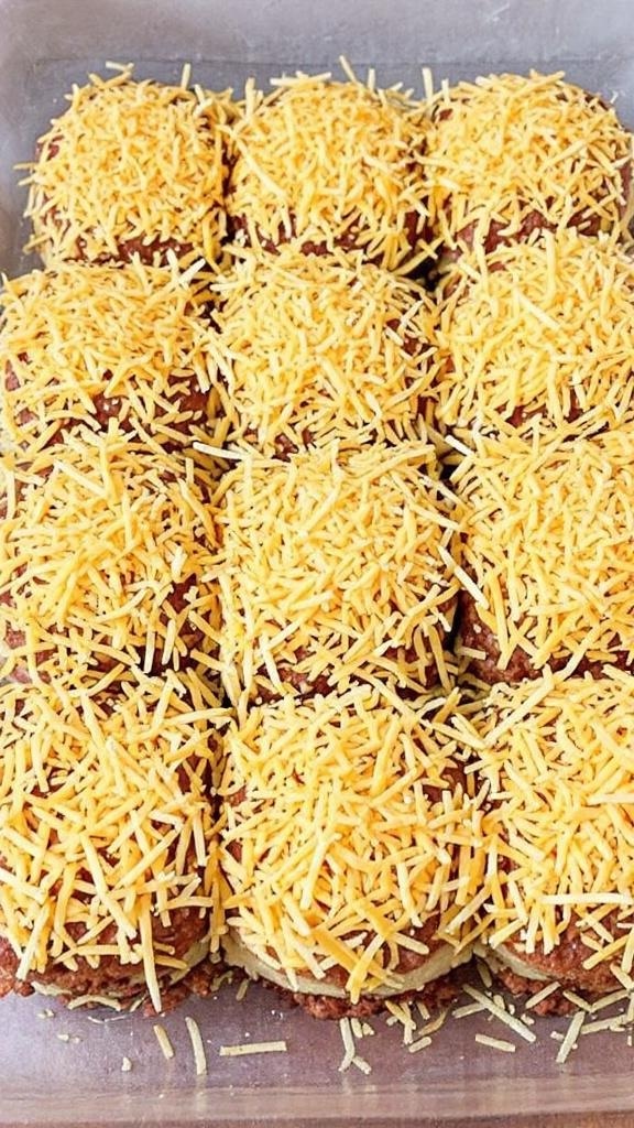 Barbecue sloppy joes topped with shredded cheddar cheese