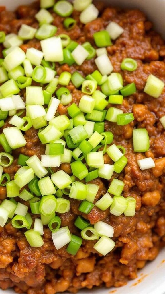 A bowl of sloppy joe mixture topped with green onions, served with a spoon.